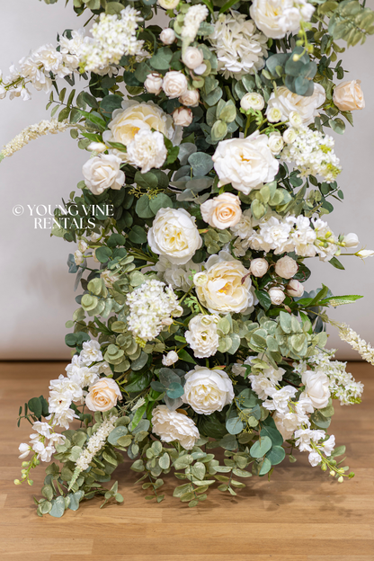 Close-up detail shot of lush, romantic wedding floral arbor studded with an abundance of ivory and white flowers and various types of eucalyptus foliage. Flowers are very delicate and textural.